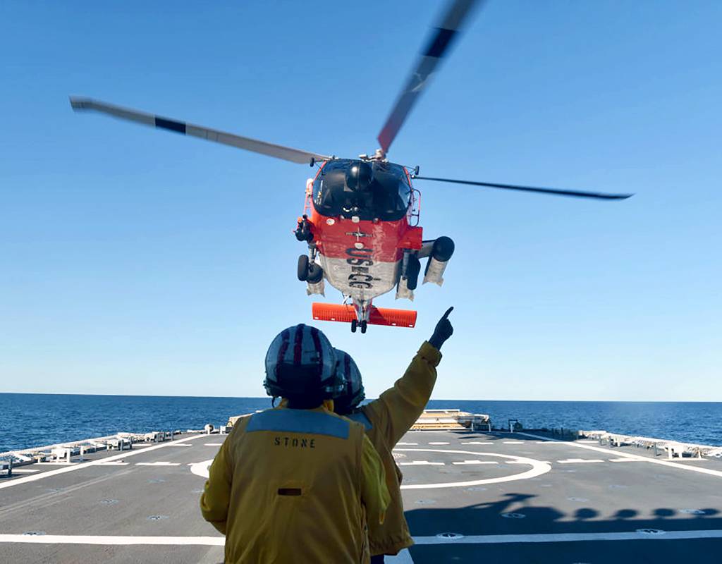 Crewmembers of the U.S. Coast Guard Cutter Stone (WMSL 758) guide an MH-60 Jayhawk helicopter to land on the Stone’s flight deck off the coast of Florida on Dec. 27, 2020. USCG Photo by Petty Officer 3rd Class John Hightower