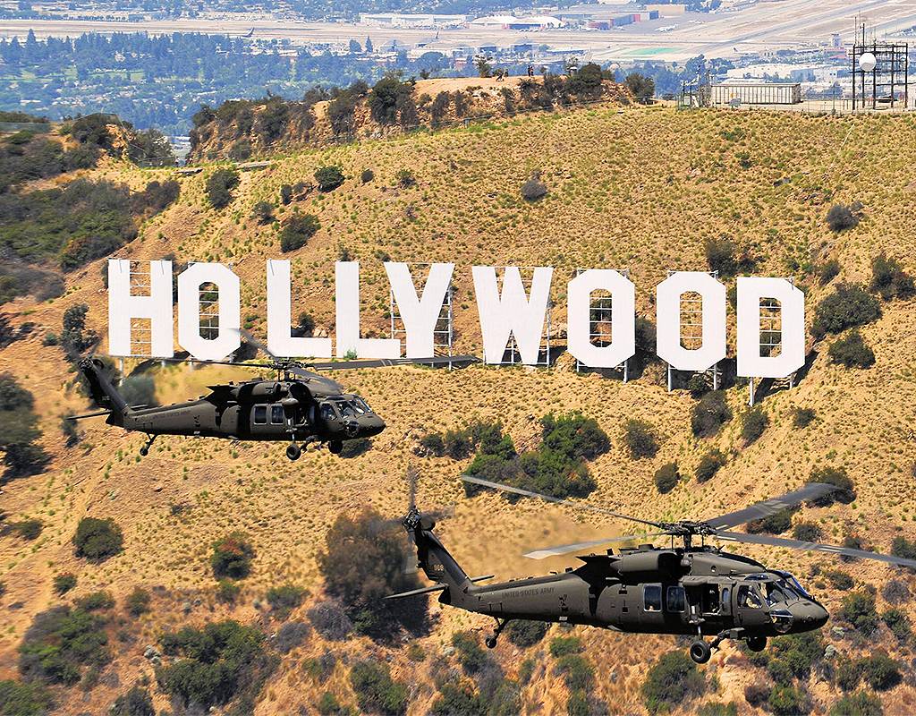 A pair of UH-60M Black Hawks cruise by the iconic Hollywood sign in the hills overlooking Los Angeles. Skip Robinson Photo