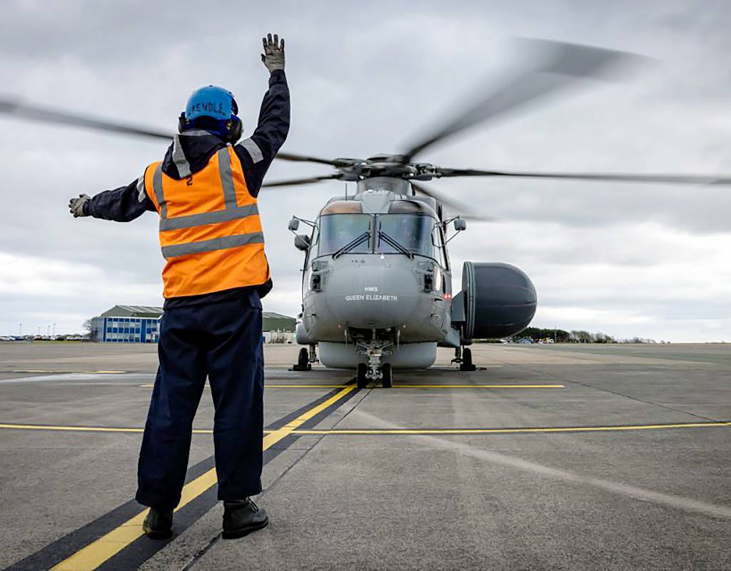 Leading Seaman Paul Rendle signals to the first Crowsnest helicopter to take off. Royal Navy Photo