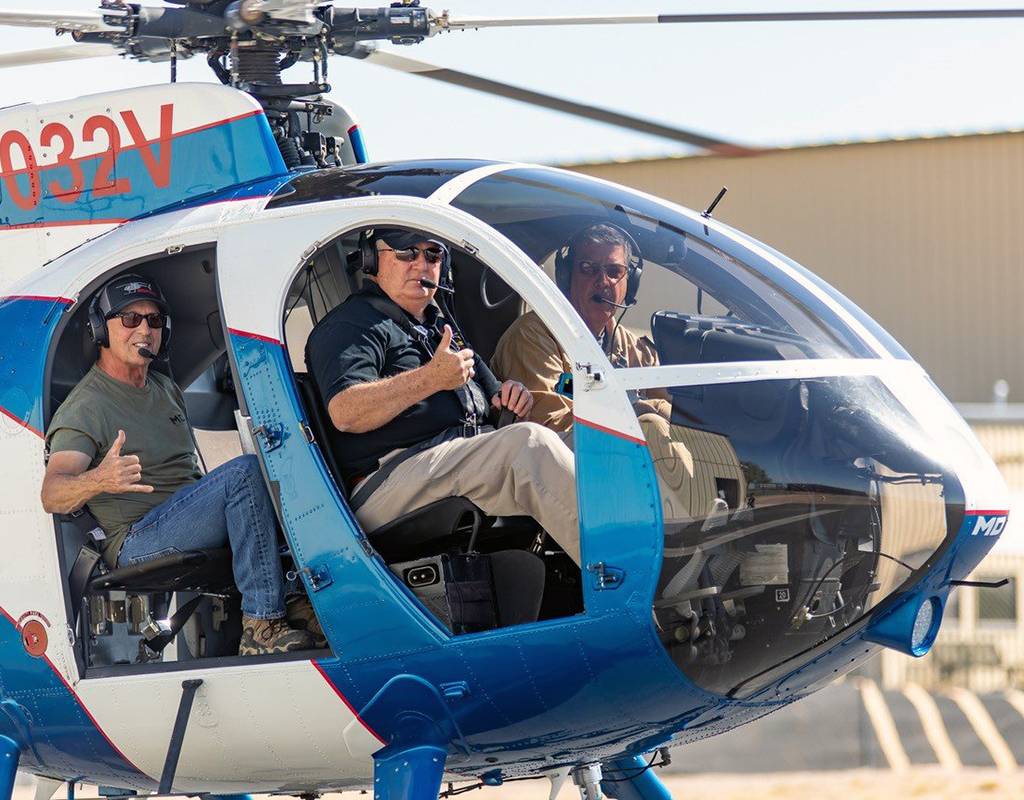 Veteran pilot Hugh Mills, Jr., takes a quick spin in an MD 500 with MDHI Senior Flight Instructor Dave Salem and Cinematography Pilot/Reporter Bruce Haffner. MDHI Photo