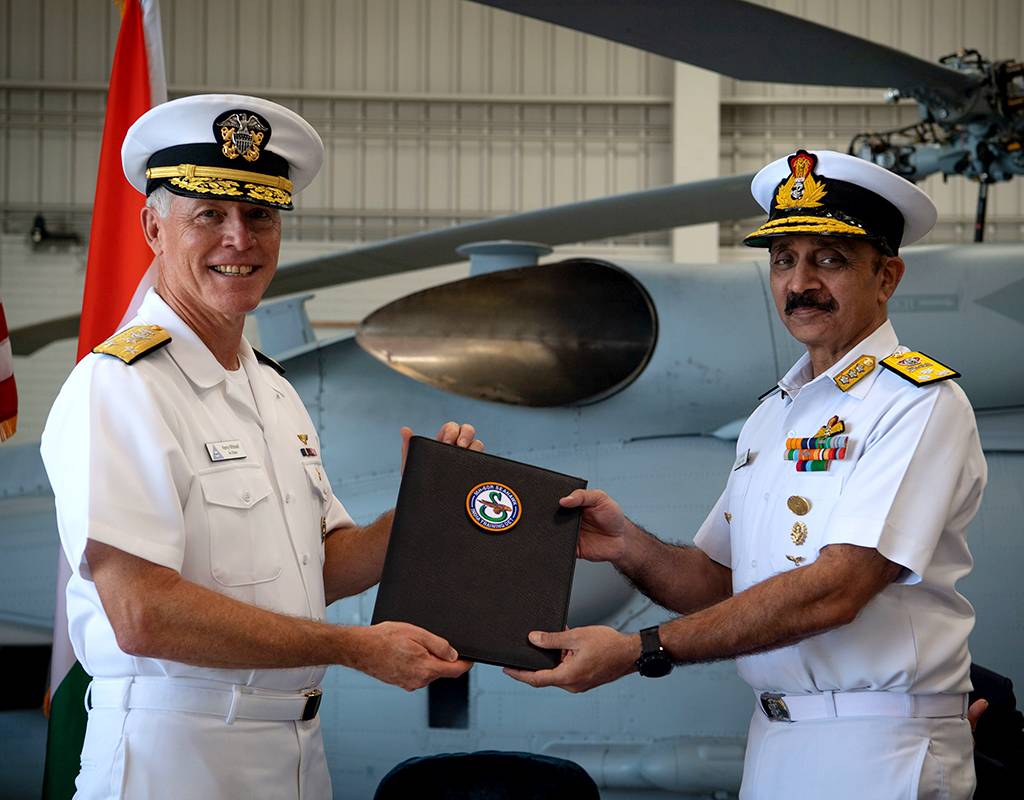 Vice Adm. Kenneth Whitesell, Commander, U.S. Naval Air Forces, left, presents the Material Inspection and Receiving Report for first aircraft to Vice Adm. Ravneet Singh, Indian Navy Deputy Chief of Naval Staff, during an acceptance ceremony at Naval Air Station North Island on Friday, July 16. MC2(SW/AW) Sara Eshleman for U.S. Navy Photo