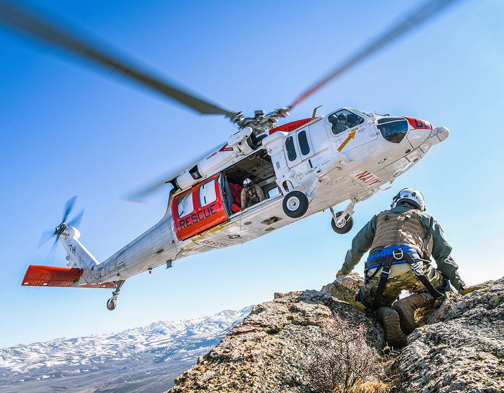 An MH-60S Knighthawk helicopter assigned to the “Longhorns” of Helicopter Search and Rescue (SAR) Squadron, practices pinnacle landings and extractions during a mountain flying SAR training event. Chief Mass Communication Specialist Shannon Renfroe for U.S. Navy Photo