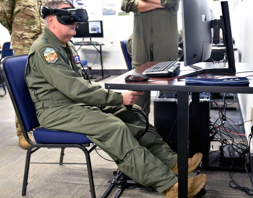 Lt. Gen. Brad Webb, commander of Air Education and Training Command, and Lt. Col. Joseph Davis, 23rd Flying Training Squadron commander, take a closer look at a virtual reality simulator used in Helicopter Training Next. Lt. Col. Andy Thaggard for U.S. Army Photo