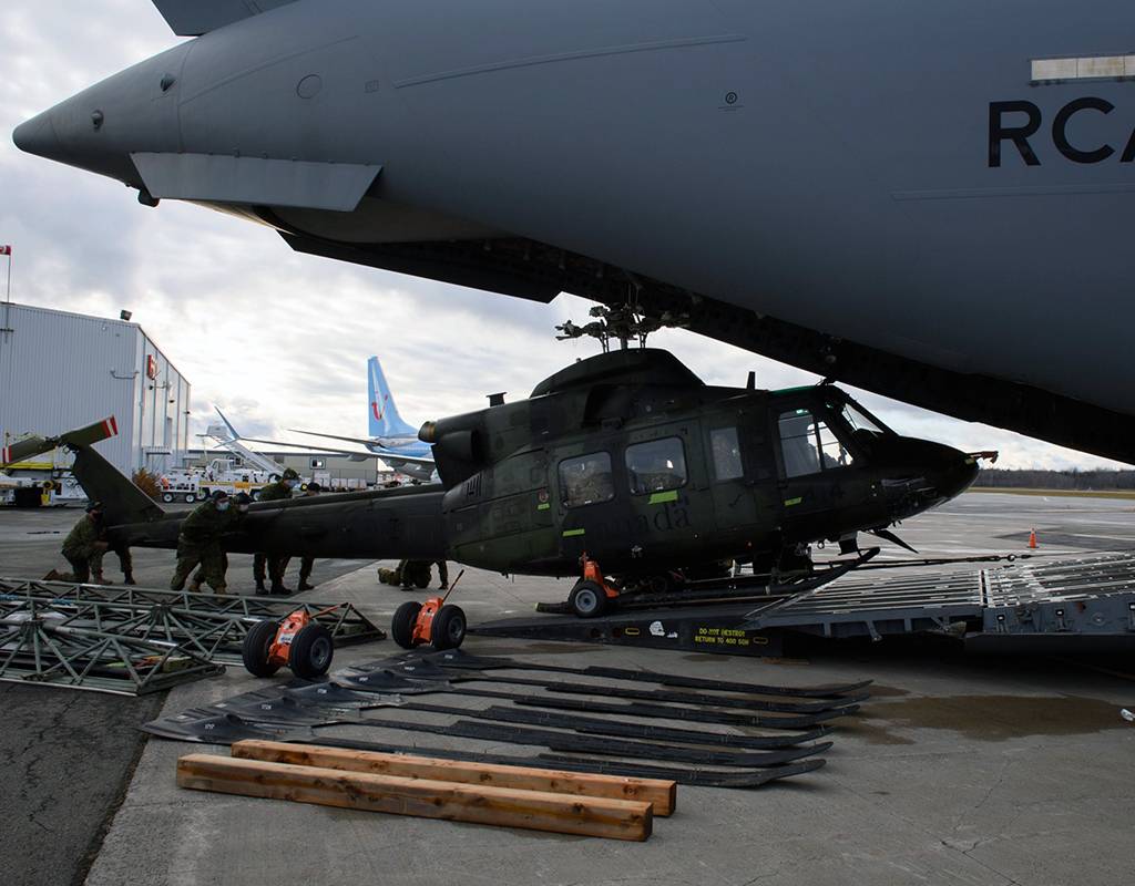 An RCAF CH-146 Griffon is loaded into a CC-177 Globemaster, one of three transported to British Columbia on Nov. 20. RCAF Photo