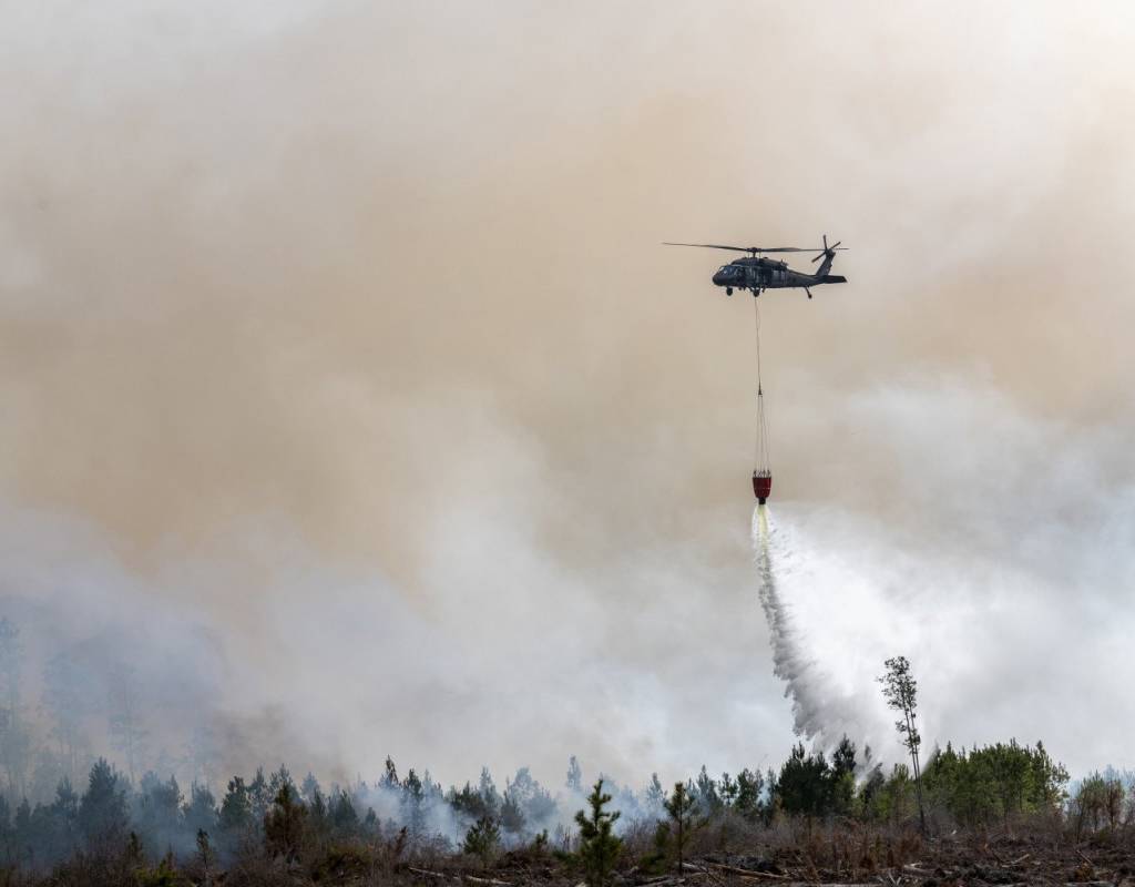UH-60 Blackhawk and CH-47 Chinook helicopter crews from the Florida National Guard support the wildfire suppression efforts in Bay County, FL March 7, 2022. The Florida National Guard is working closely with state and local partners to contain the Chipola Complex fires across multiple counties in the Florida panhandle. Master Sgt. Christopher Milbrodt for U.S. Air Force Photo
