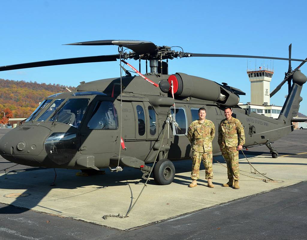 Chief Warrant Officer 4 Frank Madeira, left, and Chief Warrant Officer 4 Justin Meyer, both instructor pilots at the Eastern Army National Guard Aviation Training Site, pose in front of a UH-60V Black Hawk helicopter on Muir Army Airfield at Fort Indiantown Gap, Pa., on Nov. 10, 2021. Brad Rhen Photo