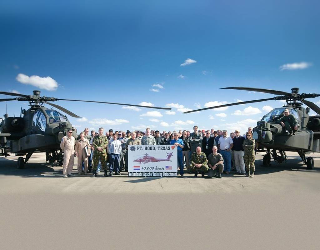Members of the 302nd Dutch Squadron pose for a photo between two Apache helicopters after the squadron reached 10,000 flight hours in the Apache on Feb. 5, 2009. Recently, the squadron surpassed 25,000 flight hours on the aircraft. Fort Hood Sentinel File Photo