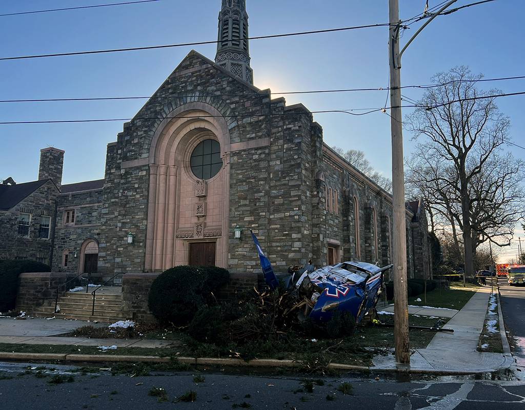 The wreckage of an Air Methods-owned H135 rests against the corner of a Drexel Hill United Methodist Church in Philadelphia on Jan. 11.