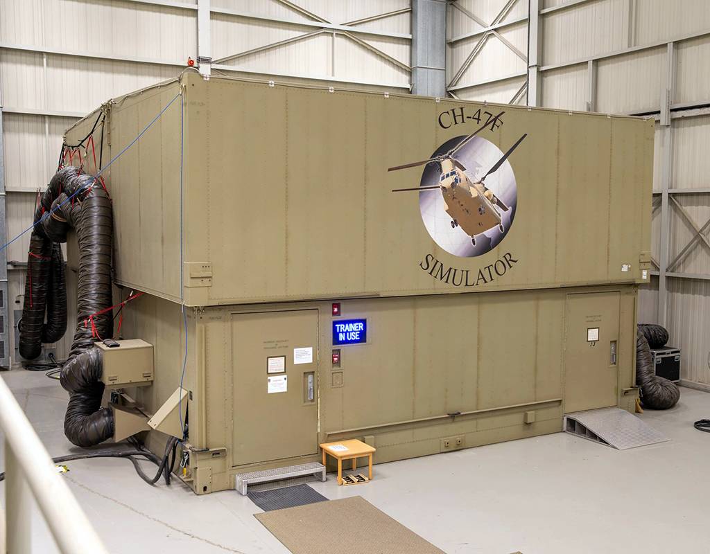 The exterior of the CH-47F Chinook helicopter simulator sits inside of the Illesheim Flight Simulator Complex at Storck Barracks in Illesheim, Germany, Nov. 17, 2021. These simulators provide safe practice of flight operations in a controlled environment and give instant feedback of crew member training. Sgt. Tommie Berry for U.S. Army Photo