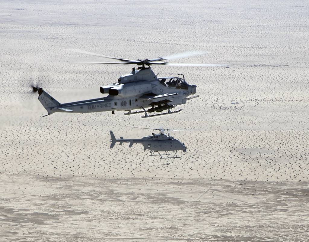 An AH-1Z Viper (top) with Marine Operational and Test Evaluation Squadron 1 (VMX-1), and an MQ-8C Fire Scout unmanned helicopter assigned to Helicopter Sea Combat Squadron 23 (HSC-23), conduct Strike Coordination and Reconnaissance Training near El Centro, California, March 10, 2022. The purpose of this exercise was to provide familiarization and concept development of manned-unmanned teaming. Lance Cpl. Jade Venegas for U.S. Marine Corps Photo