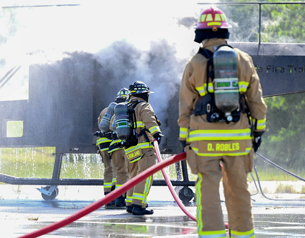 U.S. Air Force firefighters with the 908th Civil Engineer Squadron fully extinguish an internal aircraft fire during a joint interoperability training exercise, Aug. 4, 2022, at Fort Benning, Georgia. Airman 1st Class Juliana Todd for U.S. Air Force Photo