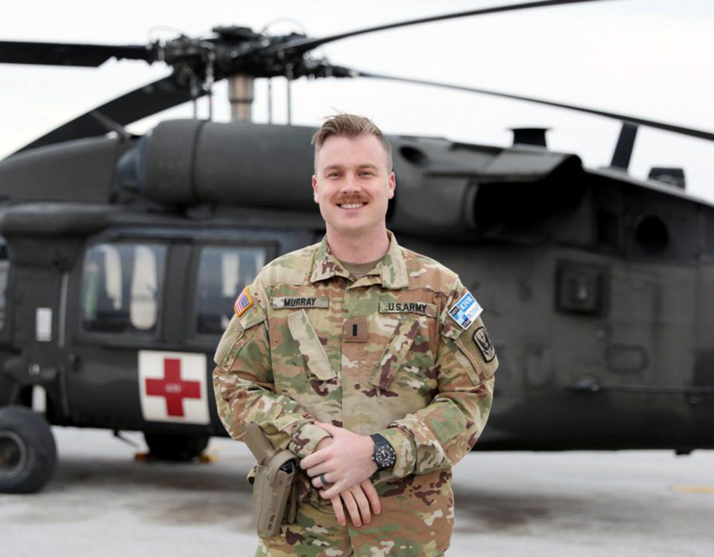 U.S. Army 1st Lt. Jonathan Murray, operations officer assigned to Detachment 2, Charlie Company, 1st Battalion, 169th Aviation Regiment, Virginia National Guard, stands in front of a medical evacuation, or MEDEVAC, UH-60 Black Hawk helicopter at Camp Bondsteel, Kosovo. Sgt. Marla Ogden for U.S. Army Photo