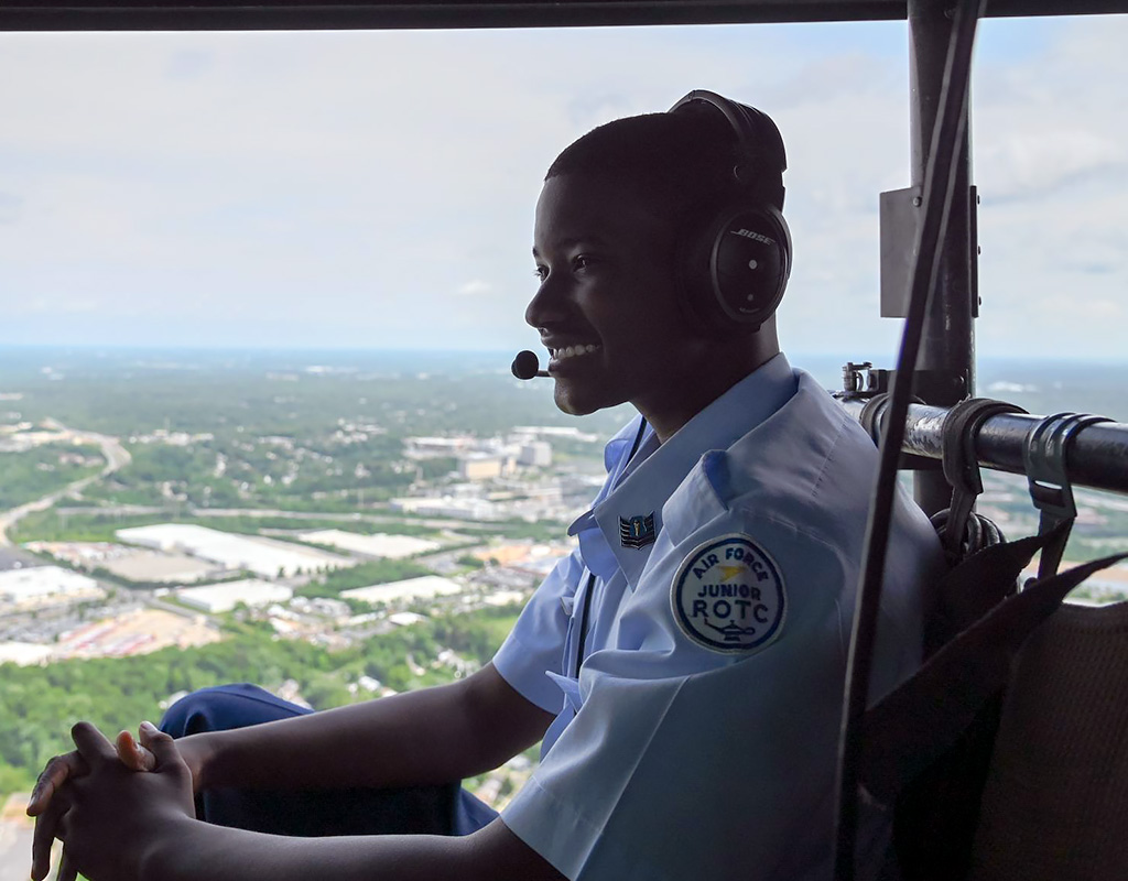 Caleb Smith, a Charles H. Flowers High School student, looks down at Washington, D.C. from a UH-1 Huey. Abigail Meyer for U.S. Air Force Photo