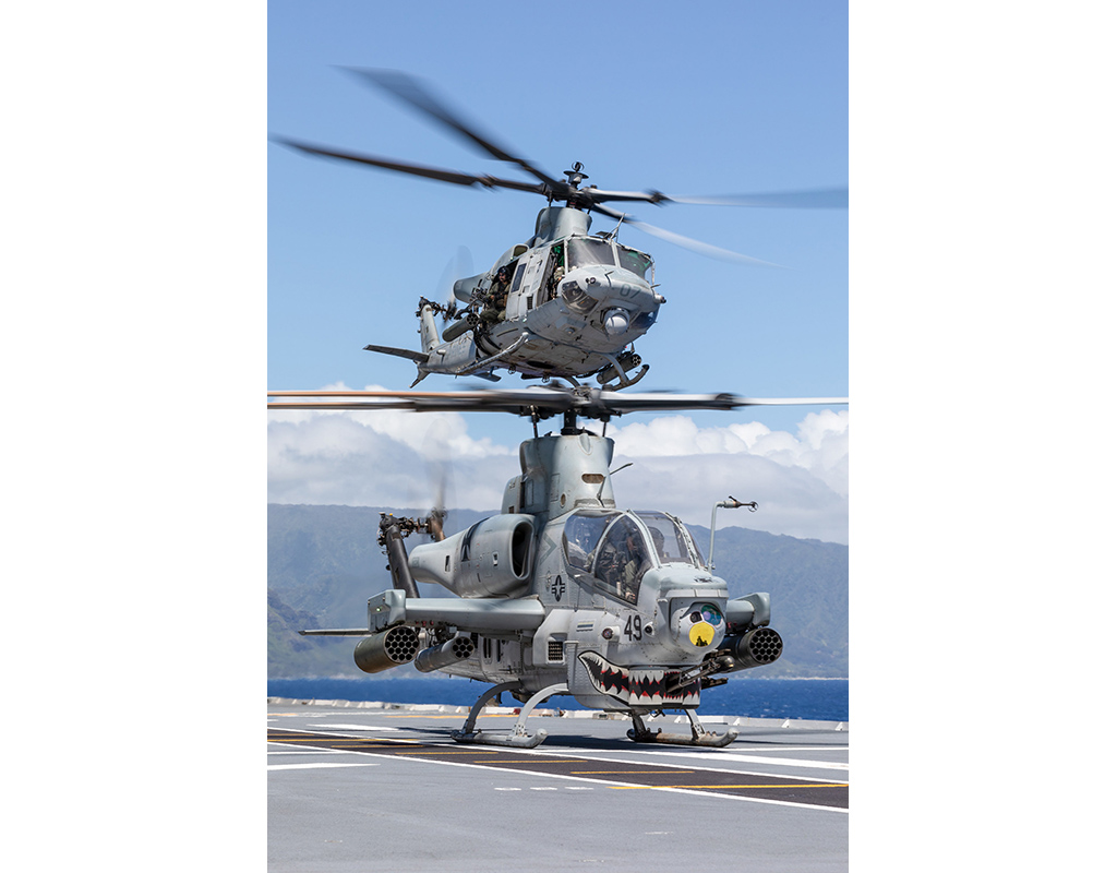 A U.S. Marine Corps UH-1Y Venom helicopter launches from the flight deck of Royal Australian Navy Canberra-class landing helicopter dock HMAS Canberra (L02) above a U.S. Marine Corps AH-1Z Viper helicopter during Rim of the Pacific (RIMPAC) 2022. Royal Australian Navy Leading Seaman Matthew Lyall Photo