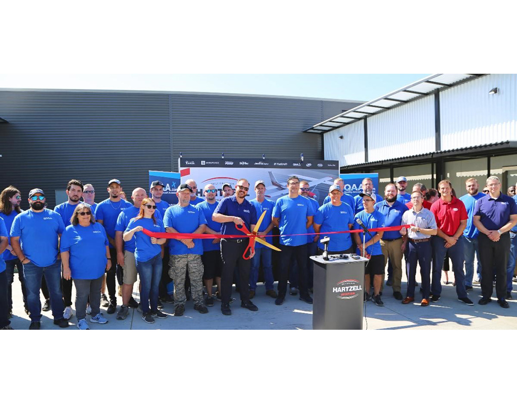 QAA general manager Brandon Stewart cuts a ribbon to signal the reopening of the company’s Tulsa operations. Hartzell Engine Tech Photo