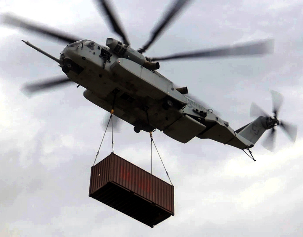 U.S. Marines with Marine Heavy Helicopter Squadron (HMH) 461 carry a cargo container with a CH-53K King Stallion at Mountain Home Air Force Base, Idaho, Aug. 11, 2022. Cpl. Adam Henke for U.S. Marine Corps Photo