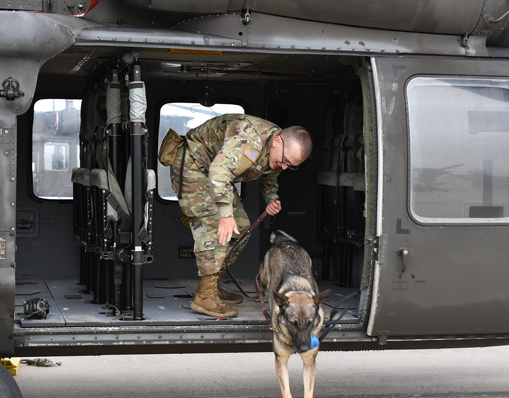 As part of the training orientation process, the dogs were led by their handlers to the flight line and practiced boarding and dismounting the helicopter while the rotors were spinning. Michelle Thum Photo
