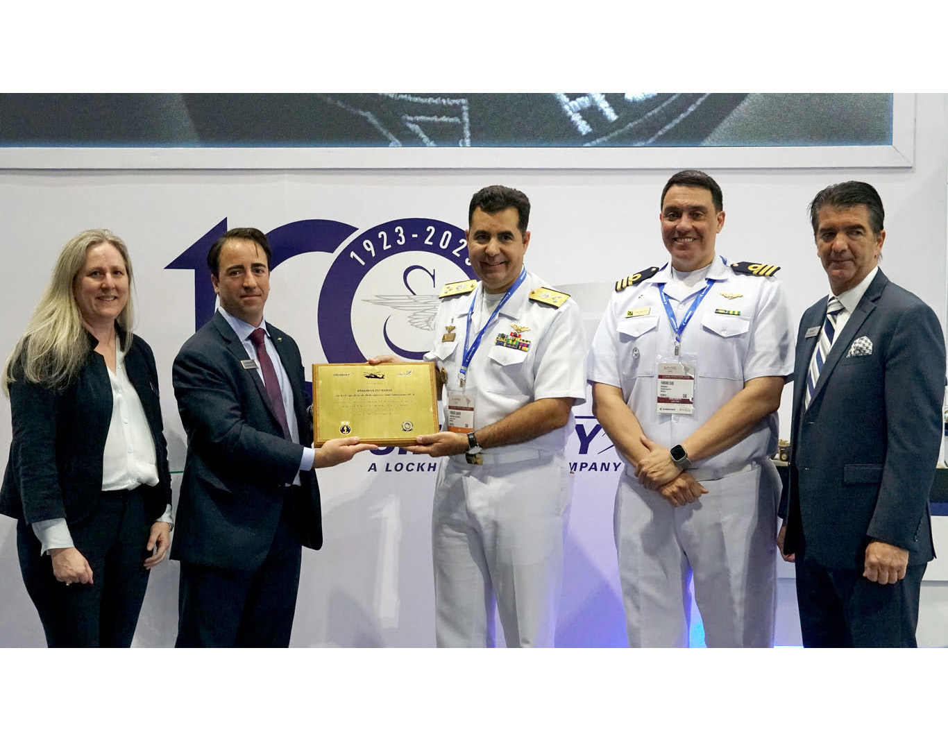 Sikorsky executives Dina Halvorsen, Felipe Benvegnu and Adam Schierholz stand with Brazilian Armed Forces representatives during LAAD 2023, April 12. Sikorsky, a Lockheed Martin company, celebrates its 100th anniversary this year. Lockheed Martin Photo