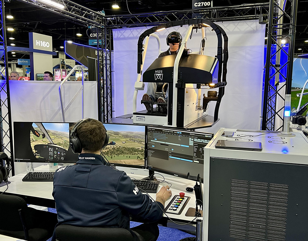 An attendee at HAI Heli-Expo 2023 sits in the Loft Dynamics virtual reality flight training device. Brent Bundy Photo