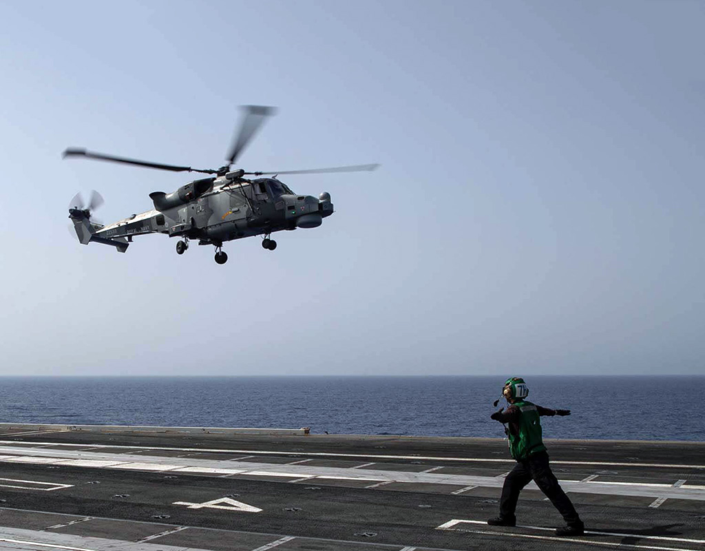 A British Royal Navy Commando Wildcat AH1 lands on the flight deck of the world’s largest aircraft carrier, USS Gerald R. Ford. Royal Navy Photo
