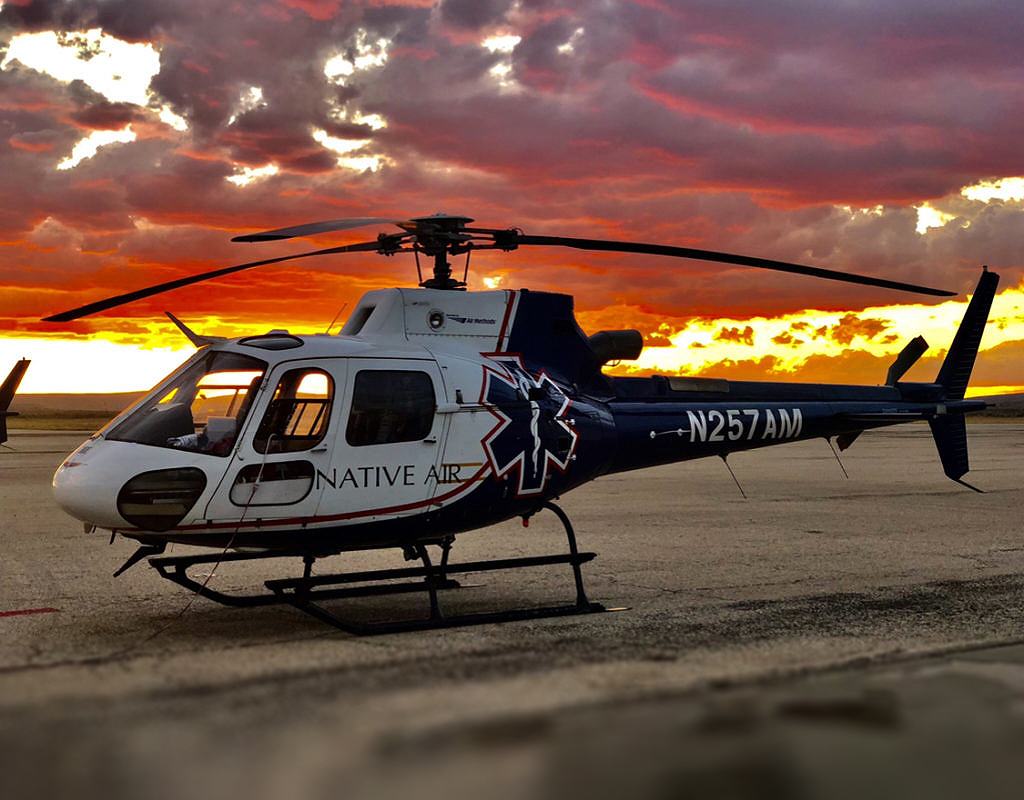 An Airbus H125 helicopter from Native Air rests at sunset. Air Methods Photo