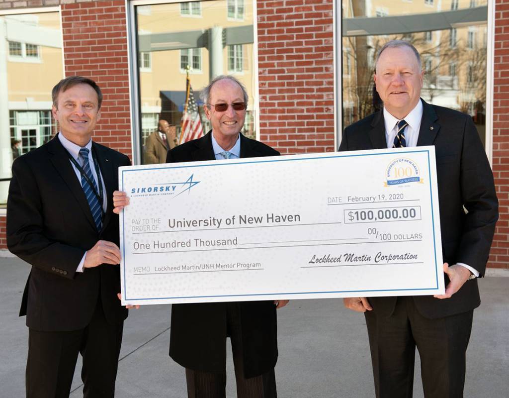 From left: Mike Ambrose, vice president of engineering and technology at Sikorsky; Steve Kaplan, president of the University of New Haven; and Dan Schultz, president of Sikorsky stand with the check for $100,000 donated by Sikorsky. Lockheed Martin Photo