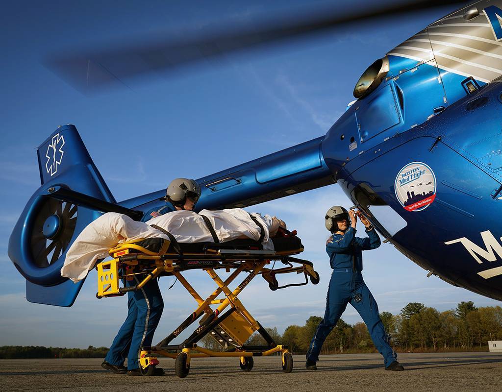 Boston MedFlight paramedics load a patient into an Airbus H145. Boston MedFlight Photo