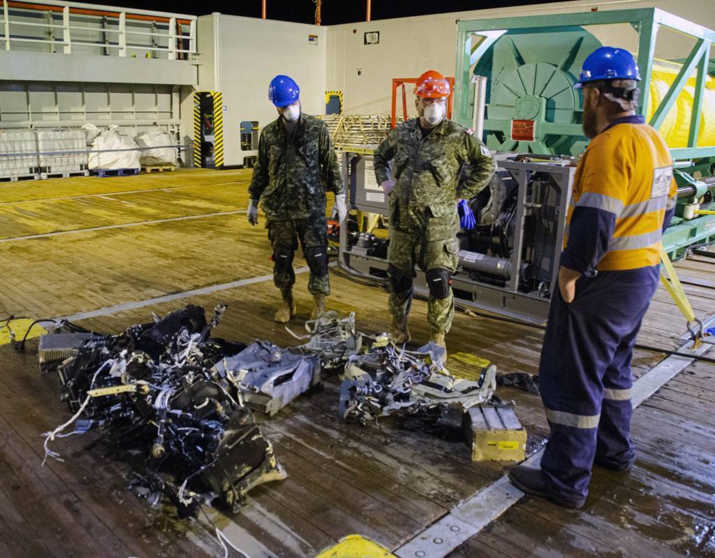 Canadian Armed Forces members and EDT Hercules personnel inspect recovered parts of Stalker 22 during recovery operations for the aircraft in the Mediterranean Sea on May 31, 2020. Cdr Robert Watt Photo