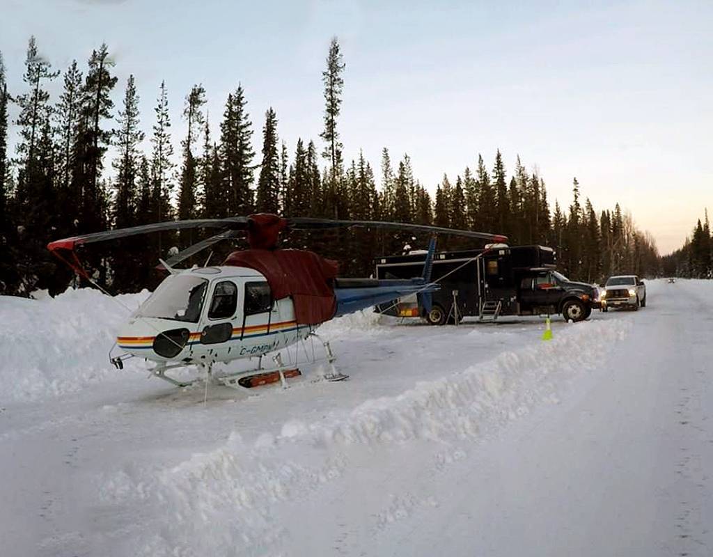 An RCMP AS350 B3 helicopter made a forced landing on a roadway after it collided with an RCMP-operated surveillance drone. Both the helicopter and the drone were damaged. Clayton Little/Global News Photo