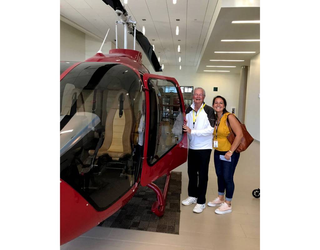 Bell’s Emma Spencer with her grandfather alongside a Bell 505 Jet Ranger X. Bell Photo