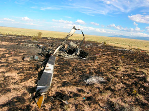 The accident helicopter impacted terrain in open ranchland, leaving a wreckage path approximately 300 feet long. NTSB Photo