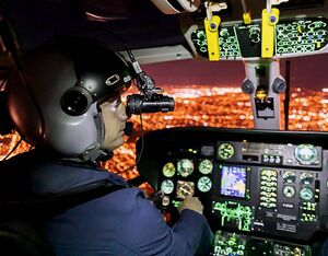 Talon Helicopters pilots Kelsey Wheeler, left, and Jarrett Lunn fly with night vision goggles in Talon’s Airbus AS365N2 Dauphin. Heath Moffatt Photo