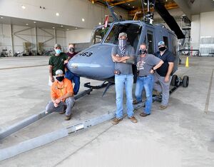 The 563rd Maintenance Squadron maintenance team with the Warner Robins Air Logistic Complex stands with a TH-1H trainer helicopter at Robins Air Force Base, Georgia. TH-1H programmed depot maintenance is proof-of-concept first at WR-ALC and will determine the feasibility of utilizing the complex as a viable source of repair for future organic rotary wing aircraft maintenance. U.S. Air Force Photo by Joseph Mather