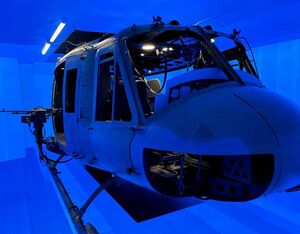 A UH-1 helicopter inside the blue electroluminescent interior of the Kratos immersive environment. Kratos Photo