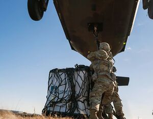 U.S. Army Sgt. Beqa Sabanashvili and Sgt. Yorby Fenandeztejada, assigned to the 145th Support Maintenance Company, New York Army National Guard, conduct sling load operations during a training mission at the Army Aviation Safety Facility in Ronkonkoma, New York, in November. Sgt. Sebastian Rothwyn Photo