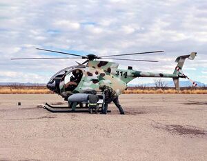 Lebanese Air Force armament personnel prepare their aircraft for aerial gunnery training. MD Helicopters Photo