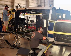 Kyle Sadler, sheet metal mechanic, left, and William Petroff, sheet metal worker, conduct maintenance and repairs on a U.S. Air Force H-1N helicopter in Fleet Readiness Center East’s facility at the Global TransPark in Kinston, NC. John Olmstead Photo