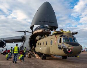 A CH-47F Chinook helicopter is unloaded from a Dover Air Force Base C-5M Super Galaxy at Royal Australian Air Force Base Townsville, Australia, July 7, 2021. Senior Airman Faith Schaefer for U.S. Air Force Photo