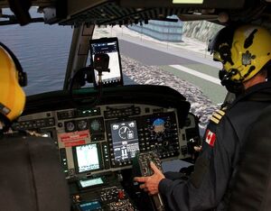 Two pilots performing a training exercise in the new full-flight helicopter simulator. CNW Group/Canadian Coast Guard Photo