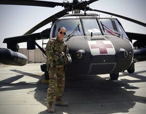 Staff Sgt. Brianna Pritchard, an Army Nation Guard UH-60 Black Hawk helicopter mechanic from Anchorage, Alaska, in front of a Task Force Phoenix UH-60 Black Hawk medieval helicopter at Al Asad Air Base, Iraq. Pritchard is training to qualify for the 2024 Paris Olympics in breaking. Sgt. Daniel Soto for Alaska National Guard Photo