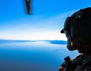 U.S. Air Force Master Sgt. Steven Prather, 56th Rescue Squadron operations superintendent, peers out the door of an HH-60G Pave Hawk A6212’s during its final flight in Croatia, Sept. 23, 2021. Senior Airman Brooke Moeder for U.S. Air Force Photo