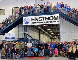 Enstrom employees pose alongside an Enstrom 480B at the company’s factory in Menominee, Michigan. Enstrom Helicopter Photo