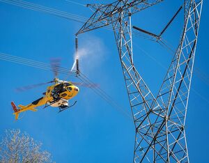 Helicopter insulation washing allows access to high and medium voltage power transmission lines. Ecocopter Photo