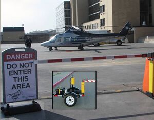 By assigning remote controls with visor clips to emergency equipment, only approved emergency vehicles could access the pad. Battery Operated Barrier Photo