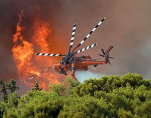 This photo of an Erickson S-64 fighting a towering Greek wildfire has been named the winner of the Vertical Photo Contest 2022. John Pitsakis Photo