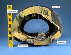 The accident aircraft’s tail boom with the fractured remains of attachment fittings and hardware. Upper-left attachment hardware (bolt, washers, and nut) was not present. The lower left, lower right, and upper right attachment hardware (bolt, washers, and nut) remained installed. NTSB Image