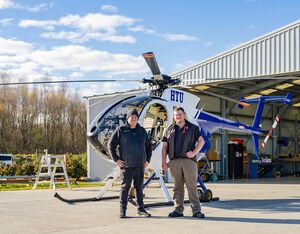 Mt Hutt Aviation employees stand with an MD helicopter. MD Helicopters Photo
