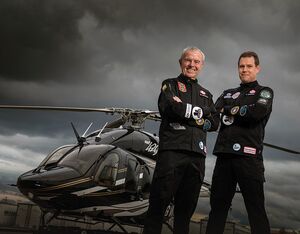 Bob, left, and Steven Dengler stand with the Bell 429 helicopter they used to circumnavigate the globe. Peter Bregg Photo