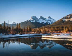 Three Sisters Peaks in the Bow River, near Canmore in Alberta