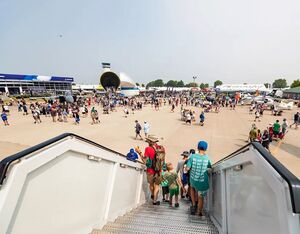 Attendees walk down a staircase from a Southwest Airlines plane into Boeing Plaza during EAA AirVenture Oshkosh 2023 on Monday, July 24, 2023, in Oshkosh, Wis. Seeger Gray/USA TODAY NETWORK-Wisconsin